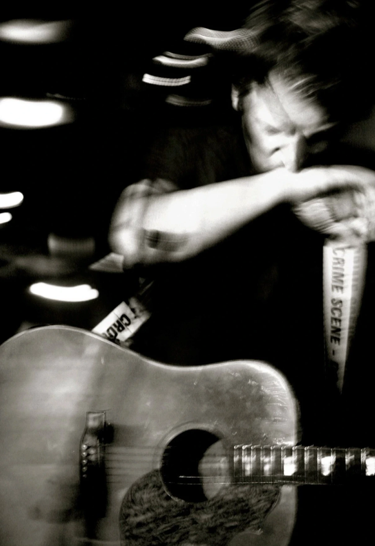 May Gil Photography - Photo of a musician with a guitar and a tilted gaze, arm in front of the mouth.